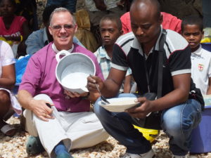 distribution ankilifaly for ambohitsabo Bishop Todd with President eating rice